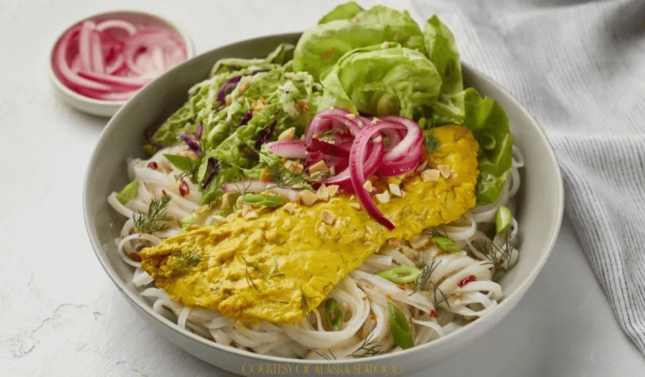 Bowl of Cha Ca Style Alaska Rockfish with noodles, pickled onions, lettuce, and herbs — Vietnamese-inspired Alaskan seafood dish