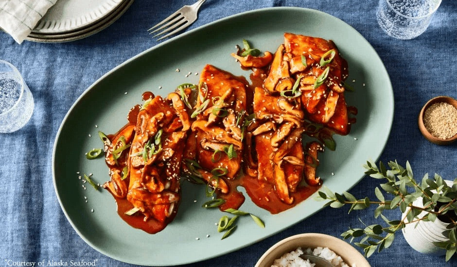 Alaska sablefish fillet glazed with gochujang marinade, plated over sticky white rice and topped with sautéed shiitake mushrooms, diced scallions, and toasted sesame seeds.