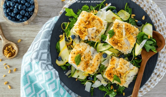 Golden panko-Parmesan crusted Alaska lingcod fillets served over a bright arugula and zucchini ribbon salad with mint, blueberries, and toasted pine nuts.