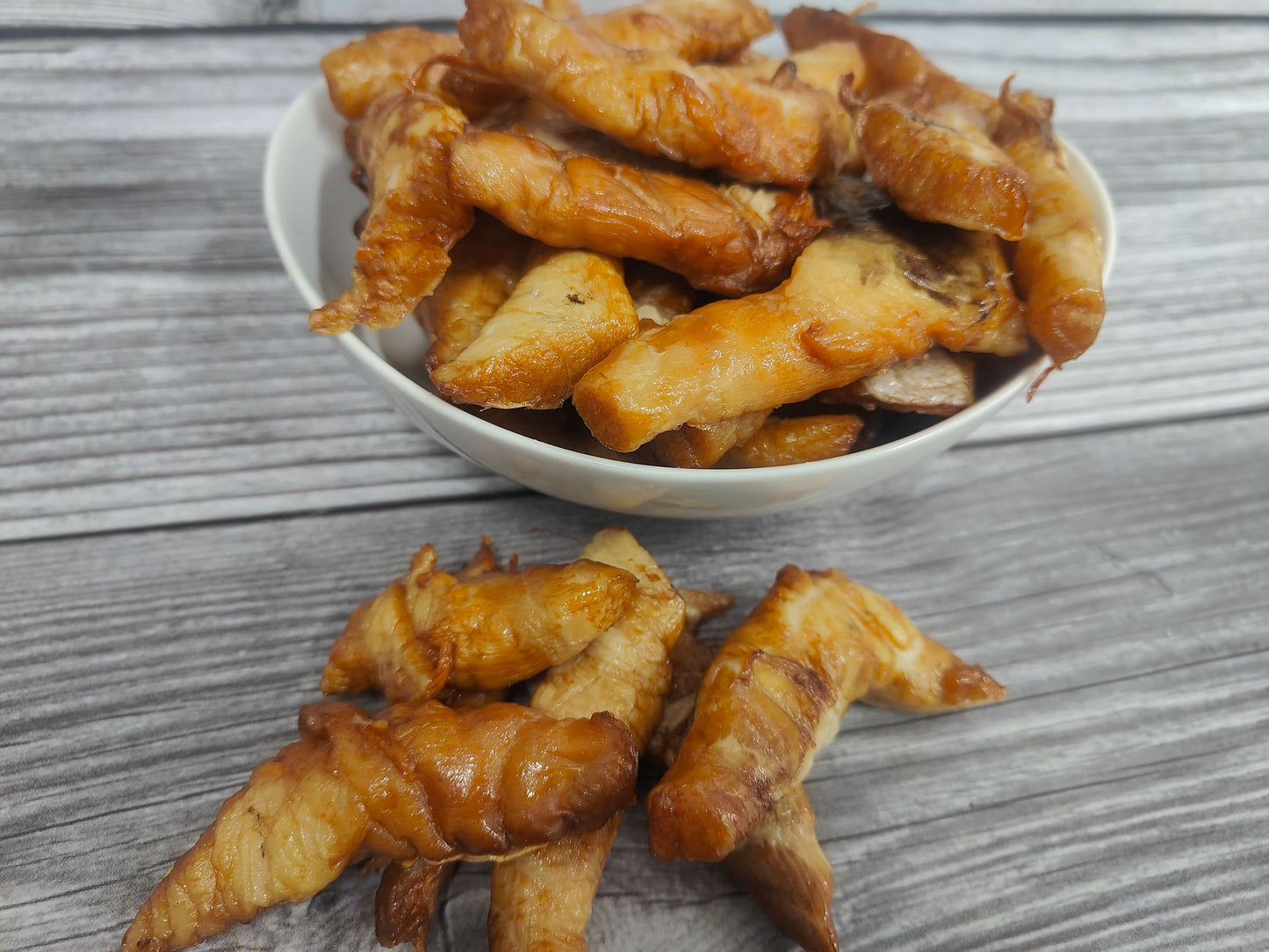 Bowl of smoked black cod tenders on a wooden surface