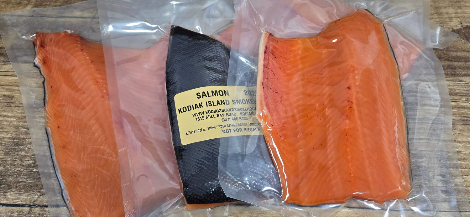 Vacuum packaged salmon fillets with a label on a wooden surface