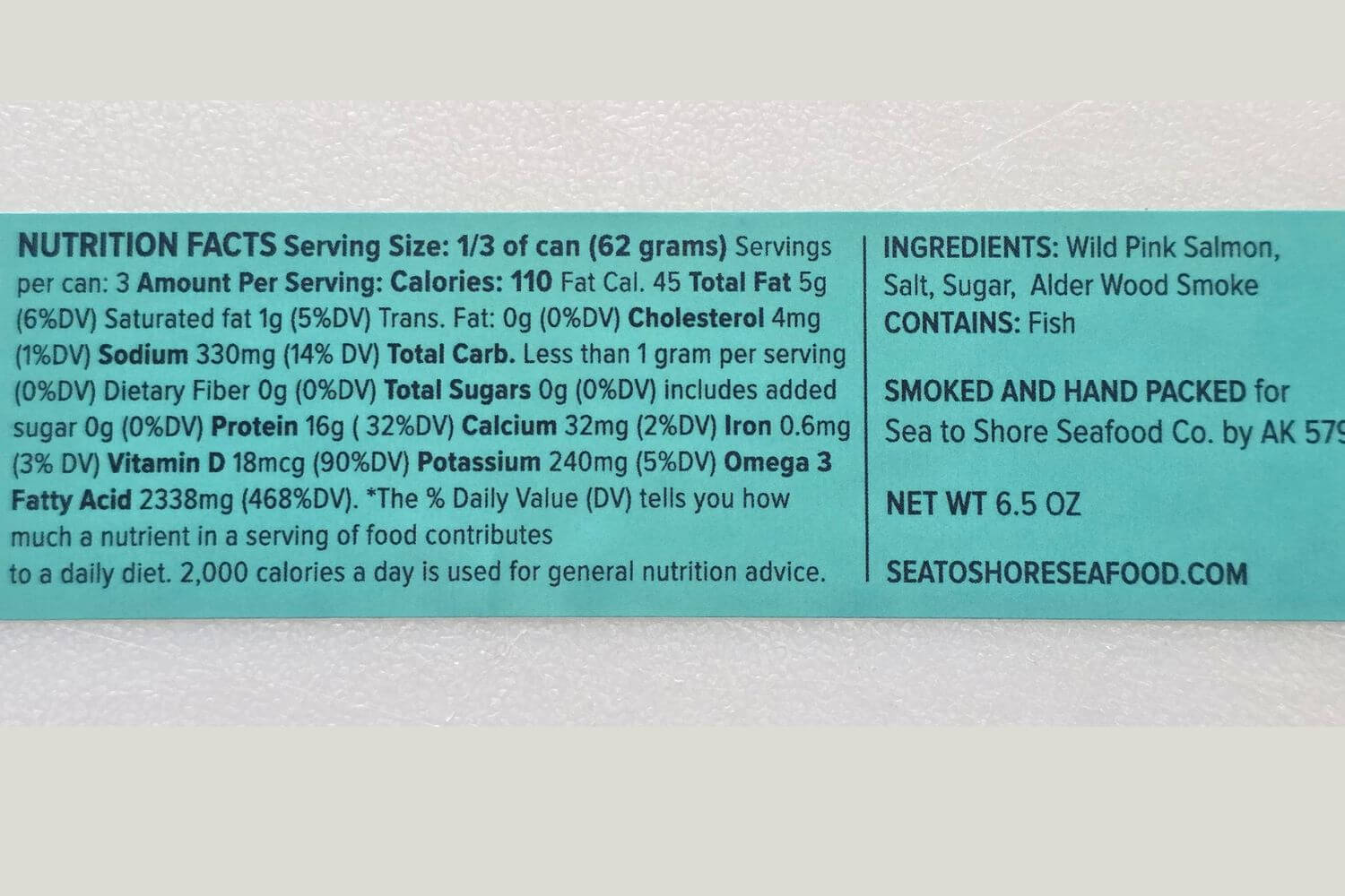 Nutrition facts and ingredients label for a can of wild Alaskan smoked pink salmon on a white background.