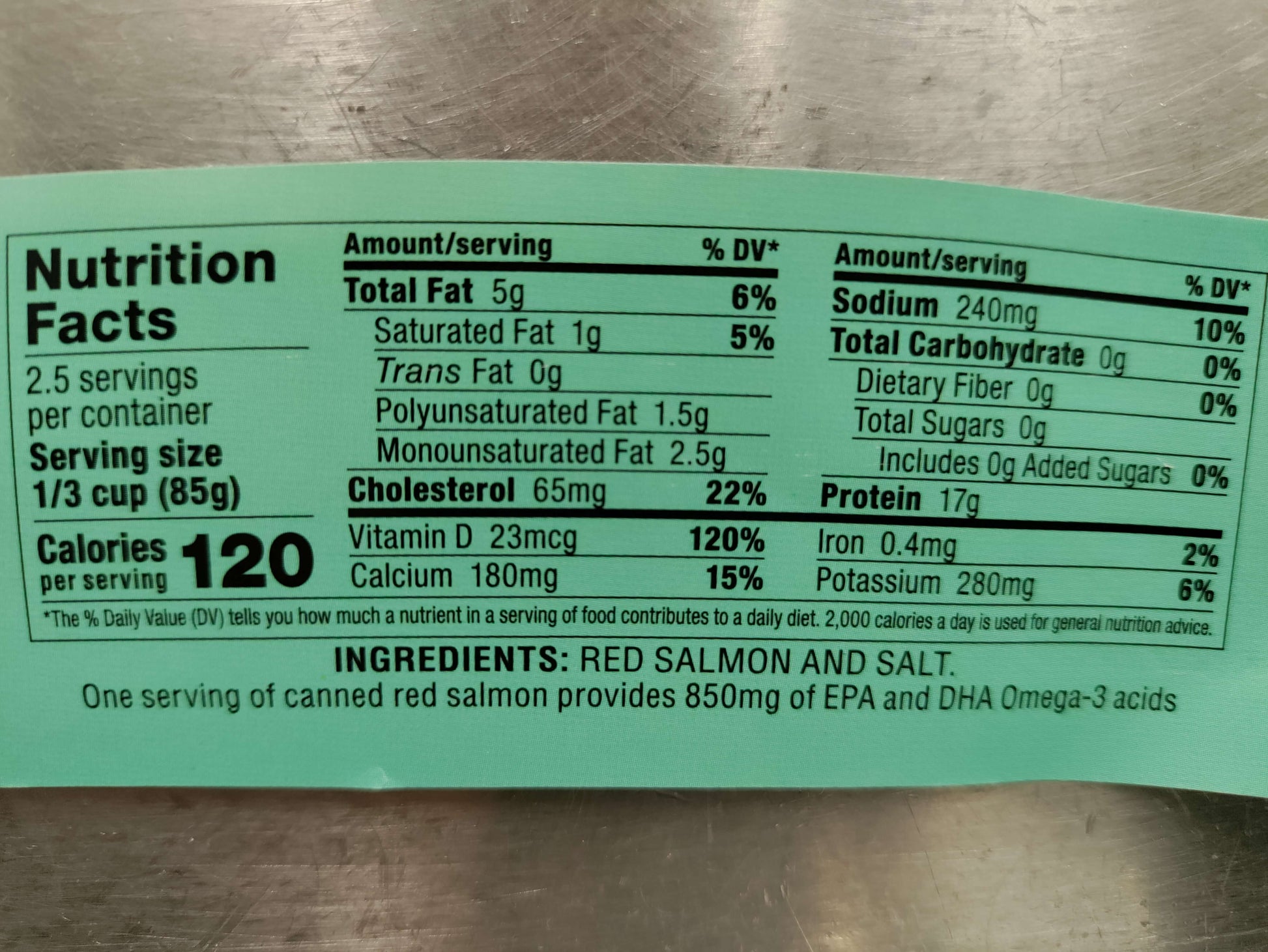 Nutrition label for canned red salmon on a metallic surface