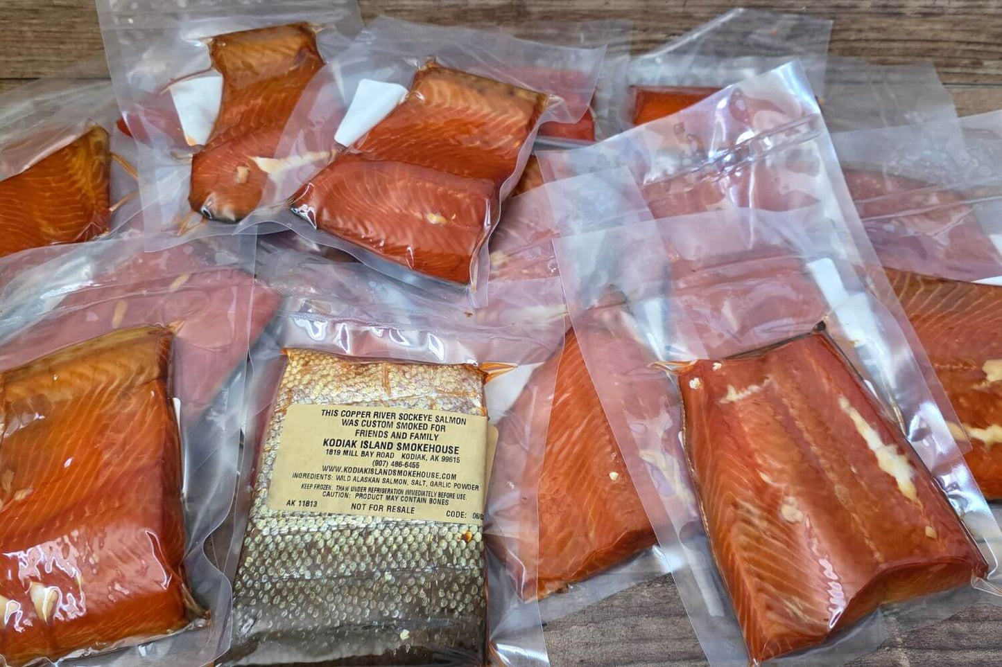 Custom-smoked Copper River sockeye salmon portions vacuum sealed and individually packaged with personalized labels in Kodiak, Alaska.