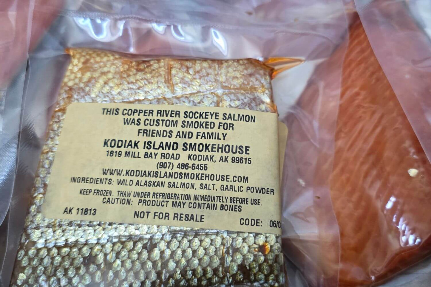 Close-up of a personalized label on custom-smoked Copper River sockeye salmon, individually packaged and vacuum sealed in Alaska.