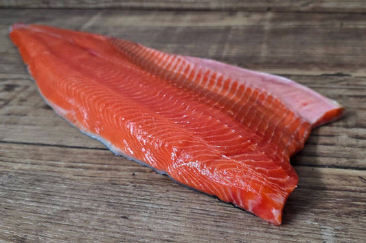 Raw Copper River sockeye salmon fillet on a wooden surface