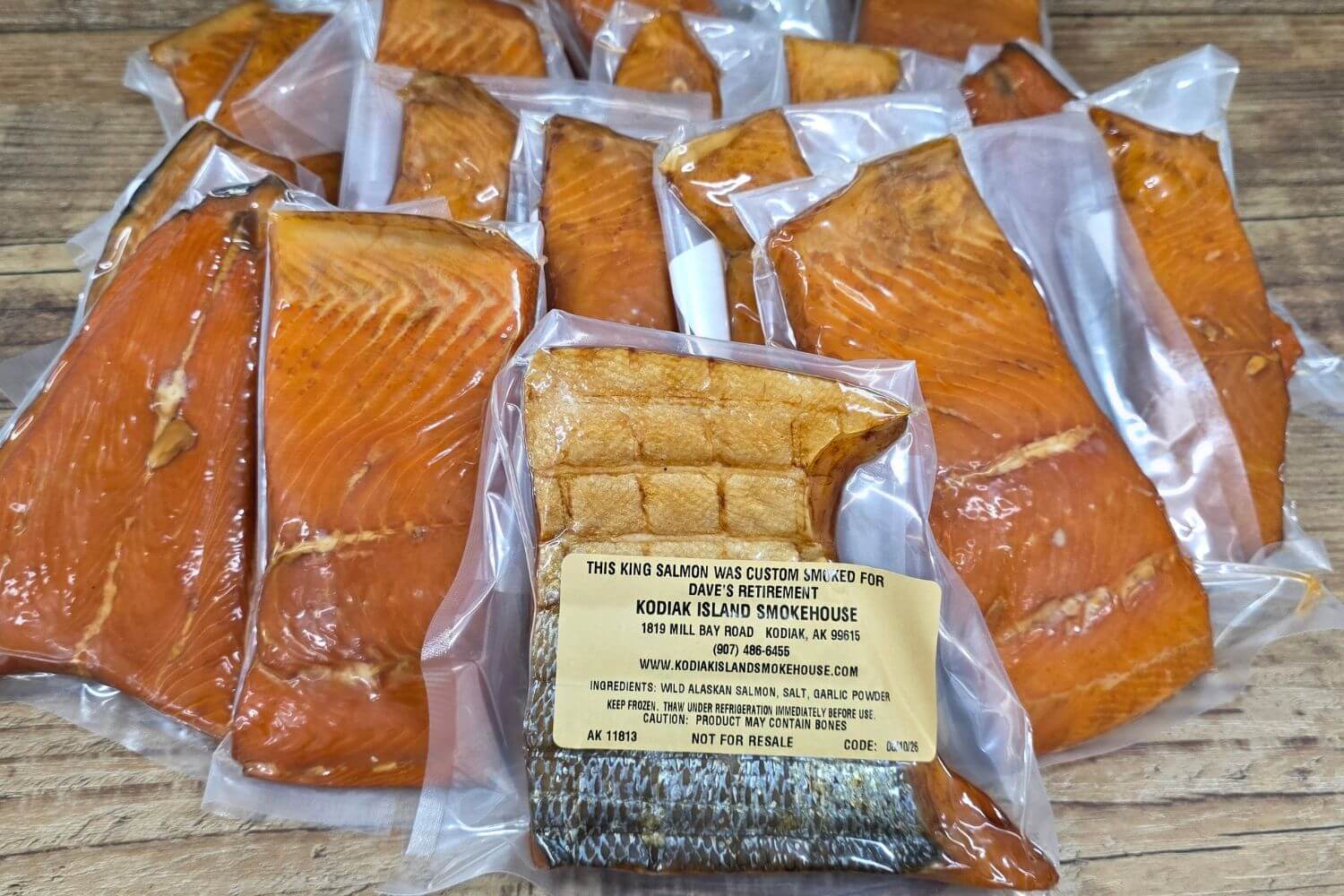 Vacuum-sealed portions of custom-smoked Alaska king salmon with a personalized package label.