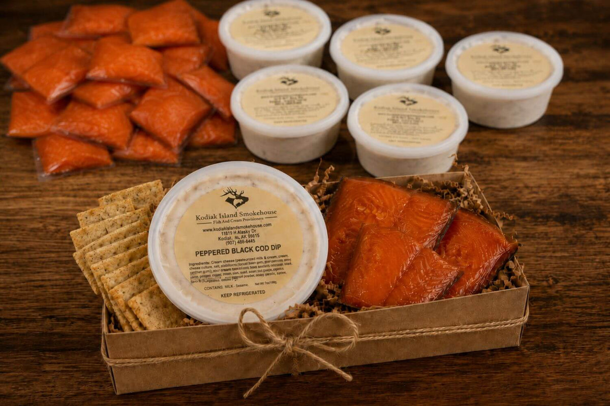 Smoked salmon dip and packaged smoked salmon arranged together as a seafood gift set.