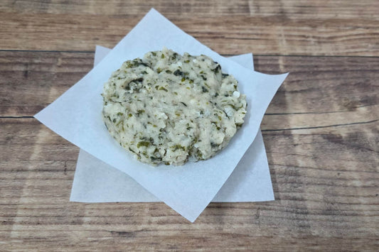 Wild Alaskan halibut burger patty with kombu kelp on parchment paper