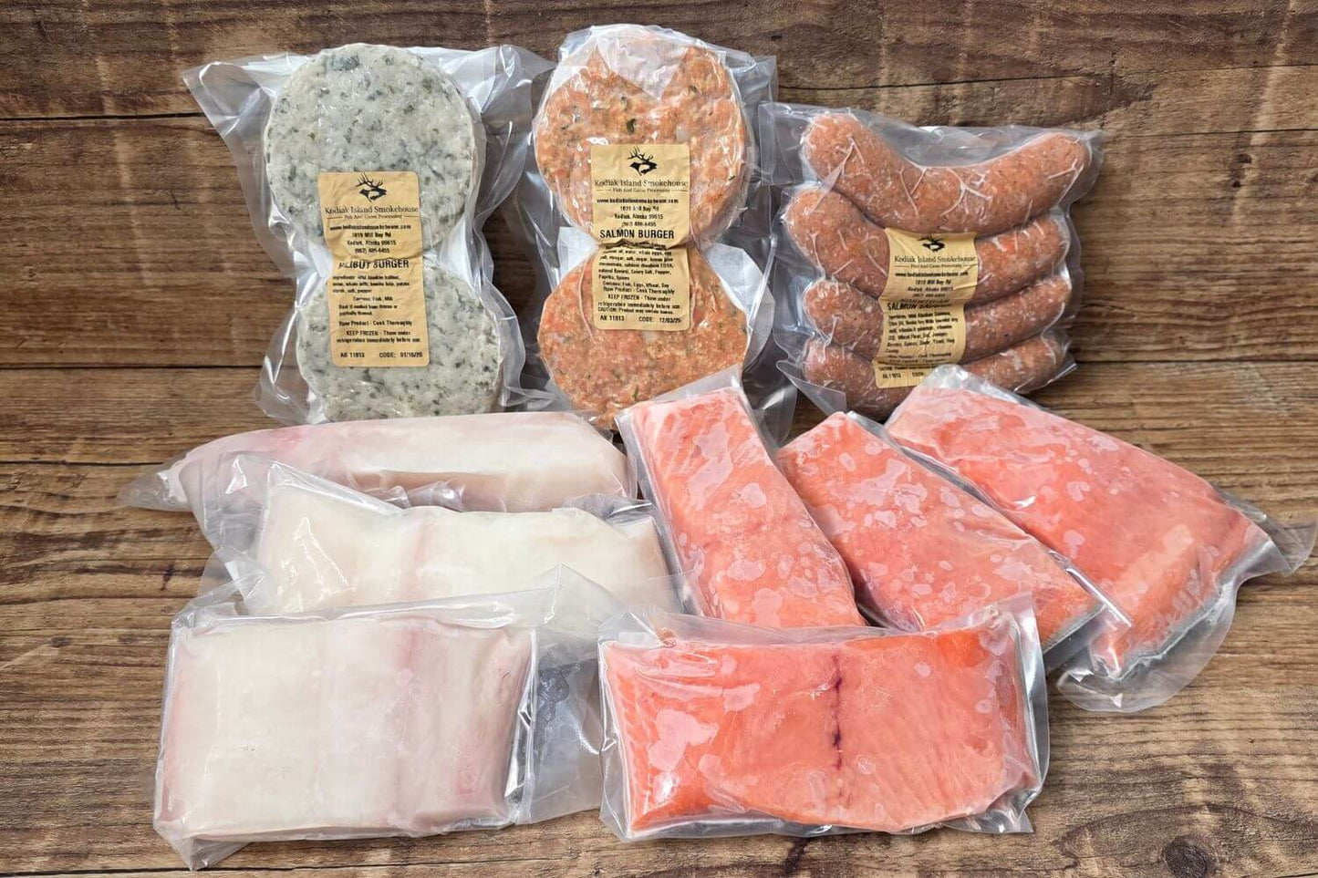 Assorted packaged seafood including king salmon & halibut on a wooden surface