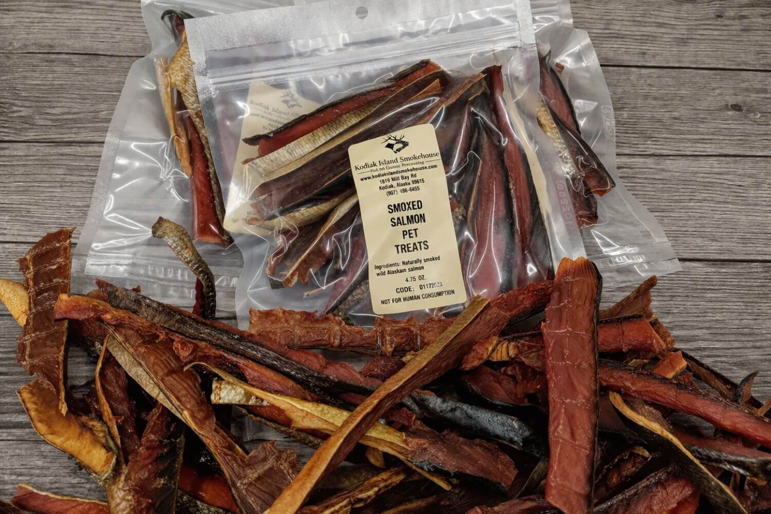 Bags of smoked salmon pet treats with visible dried salmon strips.