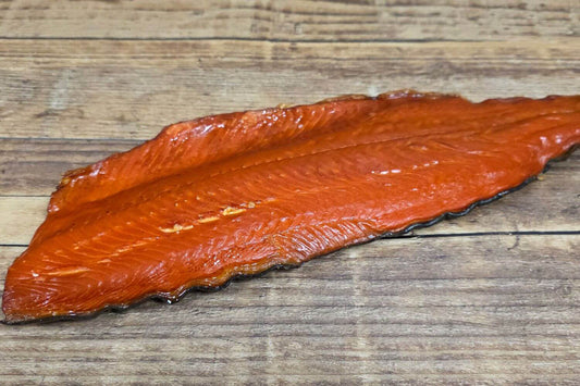Smoked sockeye salmon fillet on wooden surface