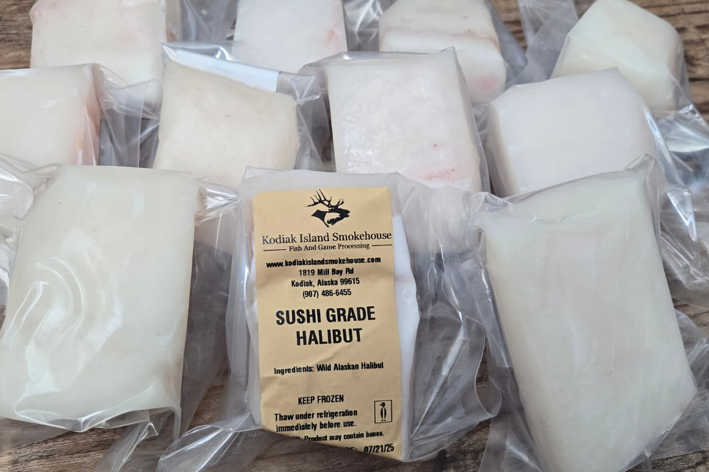 Packaged sushi grade halibut with Kodiak Island Smokehouse label on a wooden surface.