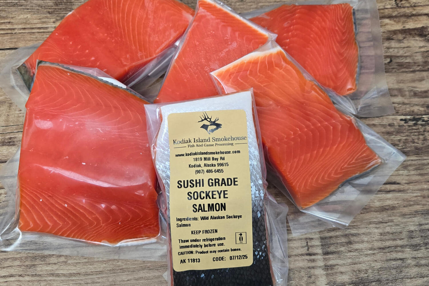 Packaged Sushi Grade Sockeye Salmon with a label on a wooden surface