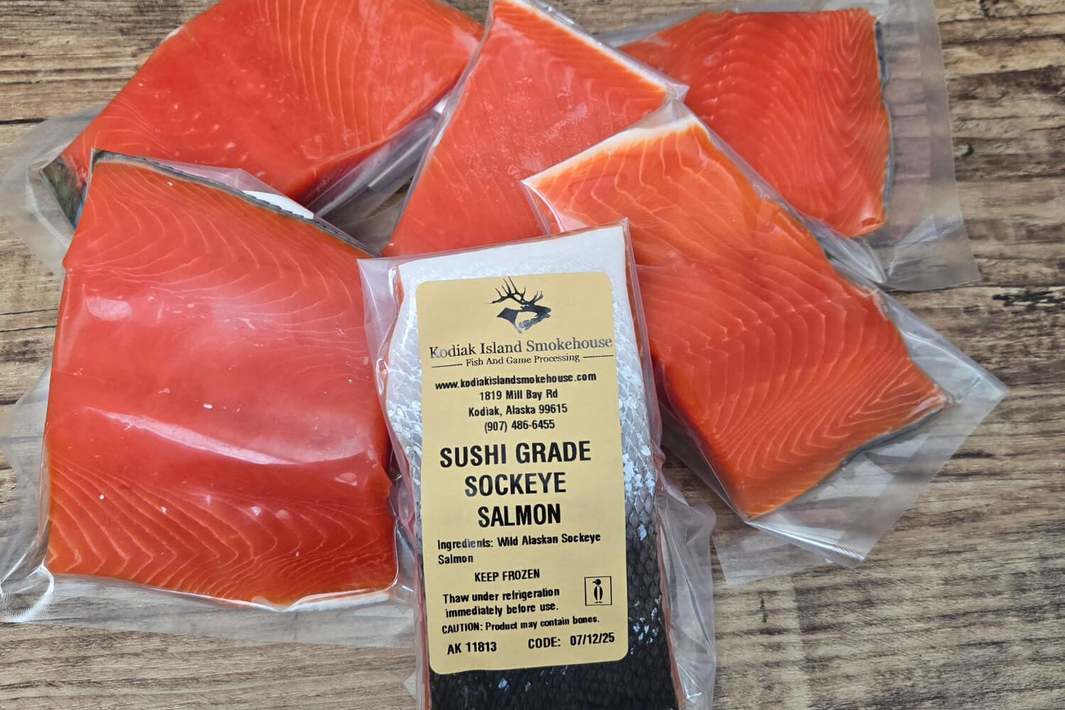 Packaged Sushi Grade Sockeye Salmon with a label on a wooden surface